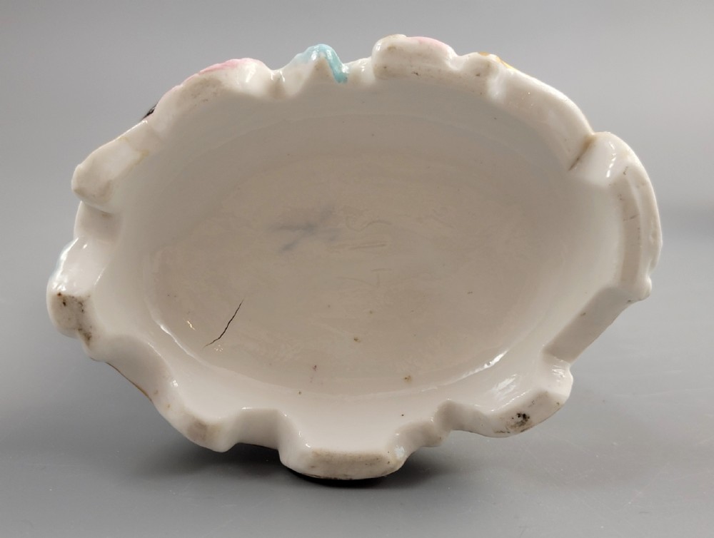 A pair of late nineteenth-century Volkstedt porcelain sweetmeat figures featuring a male and female figure picking fruit beside basket dishes on rococo bases. View VII