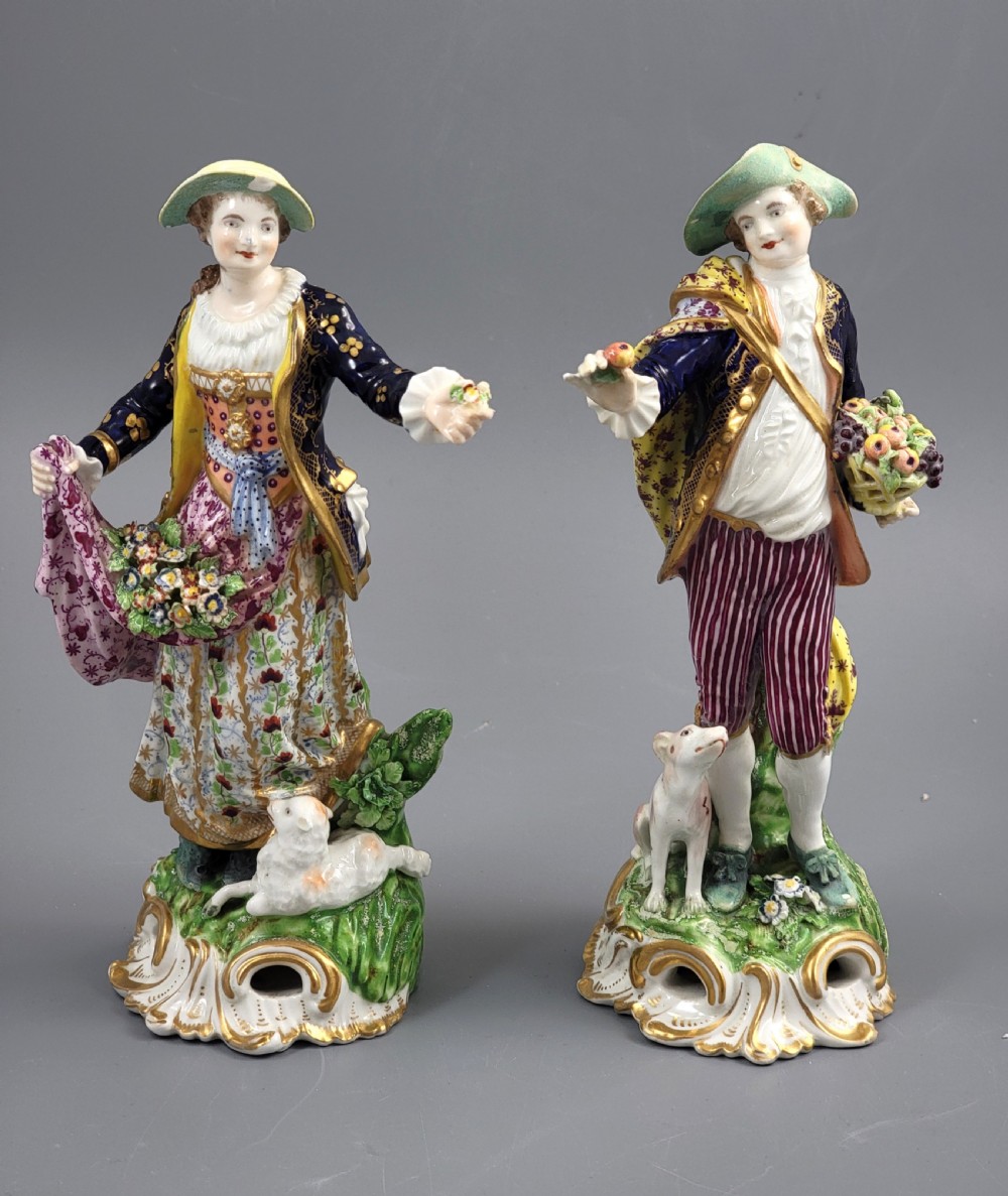 A pair of 19th-century Bloor Derby porcelain figurines depicting a shepherdess with a lamb and a shepherd with a dog, painted in multi-coloured enamels with gilded Rococo scroll bases. View V