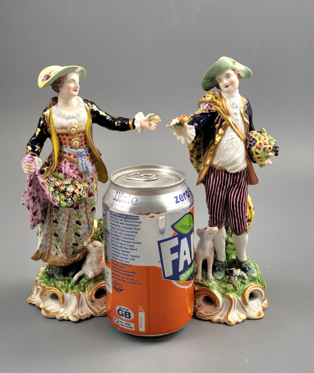 A pair of 19th-century Bloor Derby porcelain figurines depicting a shepherdess with a lamb and a shepherd with a dog, painted in multi-coloured enamels with gilded Rococo scroll bases. View XI