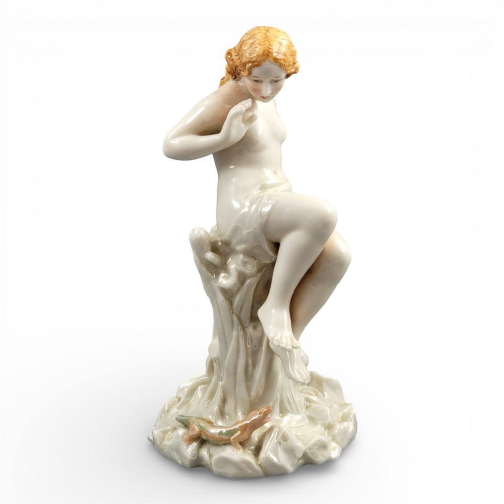 A Victorian Royal Worcester porcelain figurine depicting a seated draped female maiden on a tree stump looking down at a lizard.