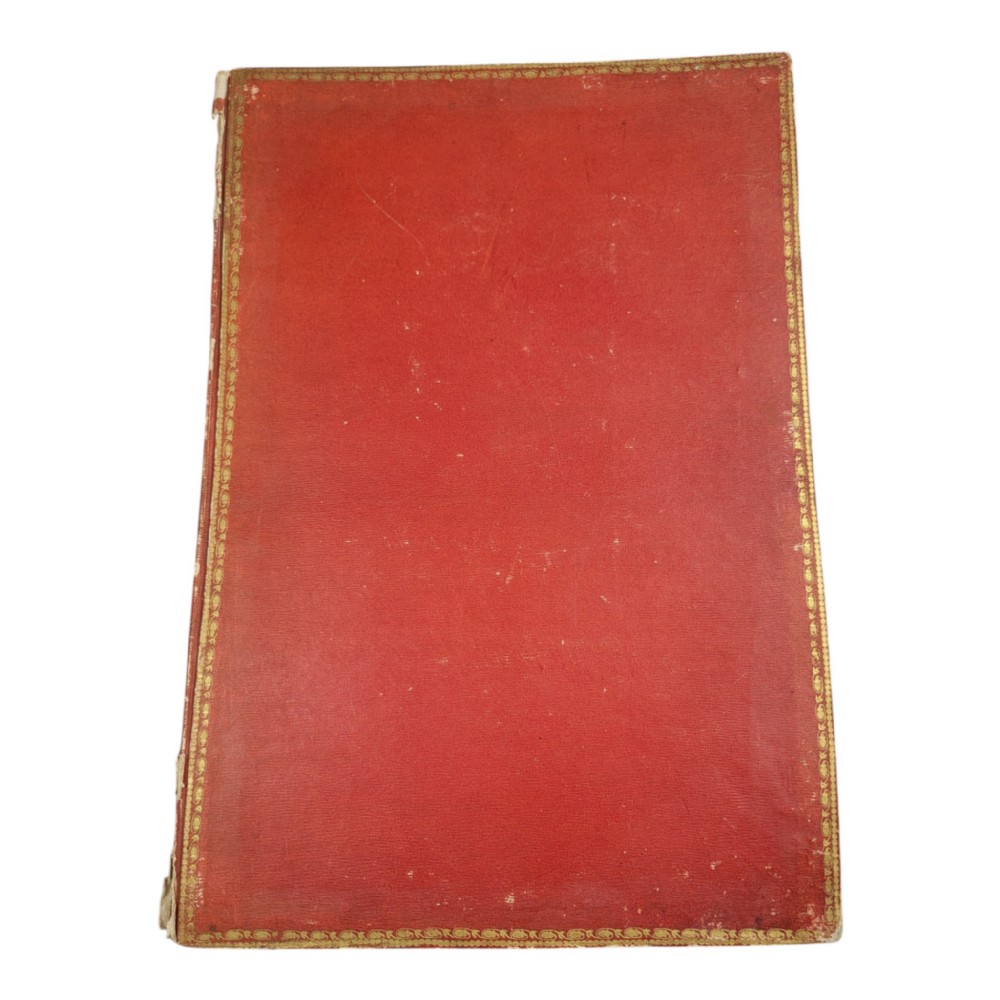A red leather-bound nineteenth-century book featuring decorative gilt tooling around the rectangular border.