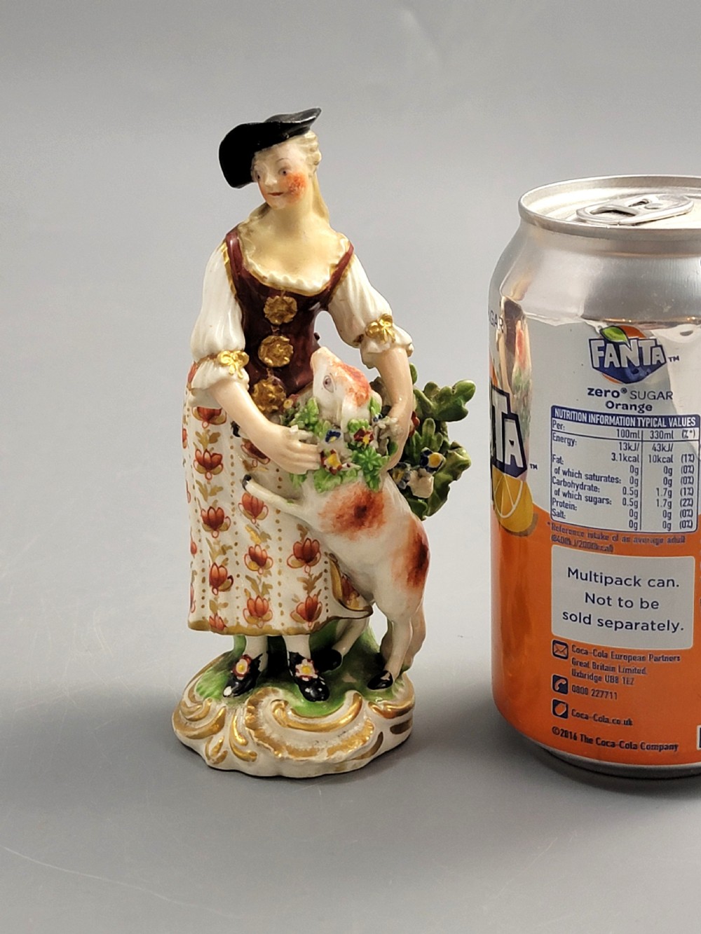 An 18th-century Derby soft-paste porcelain figurine depicting a shepherdess with a lamb on a gilded Rococo scroll base. View IX
