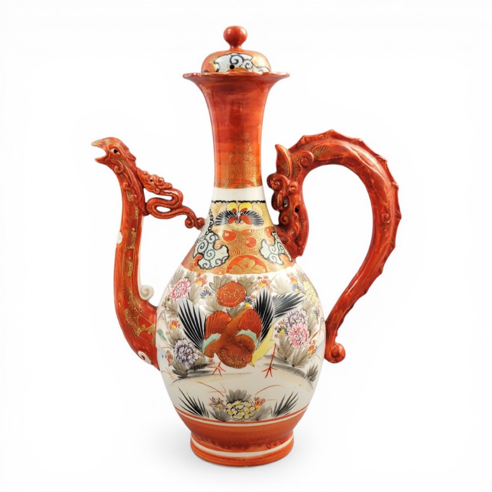 An antique Japanese Kutani porcelain ewer featuring a moulded dragon handle, a phoenix head spout, intricate polychrome floral decoration, and iron-red and gold painted accents.