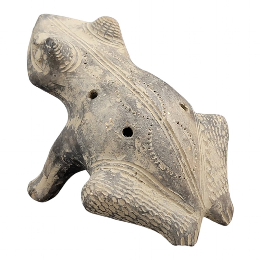 A sculpted grey earthenware whistle shaped like a frog with incised line details and finger holes along its back. View II