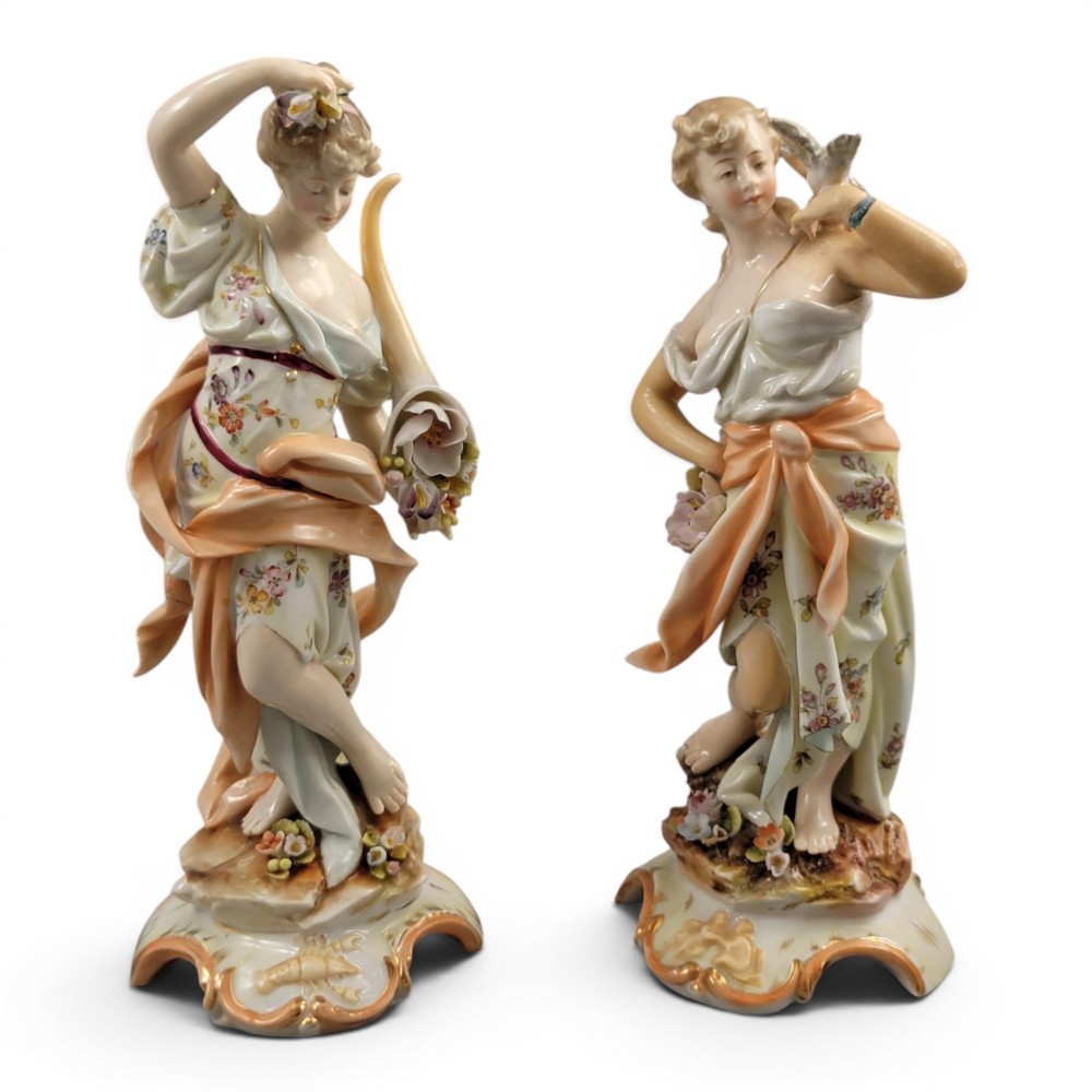 A pair of late 18th-century Volkstedt painted porcelain allegorical figures on ornate gilded scrollwork bases.