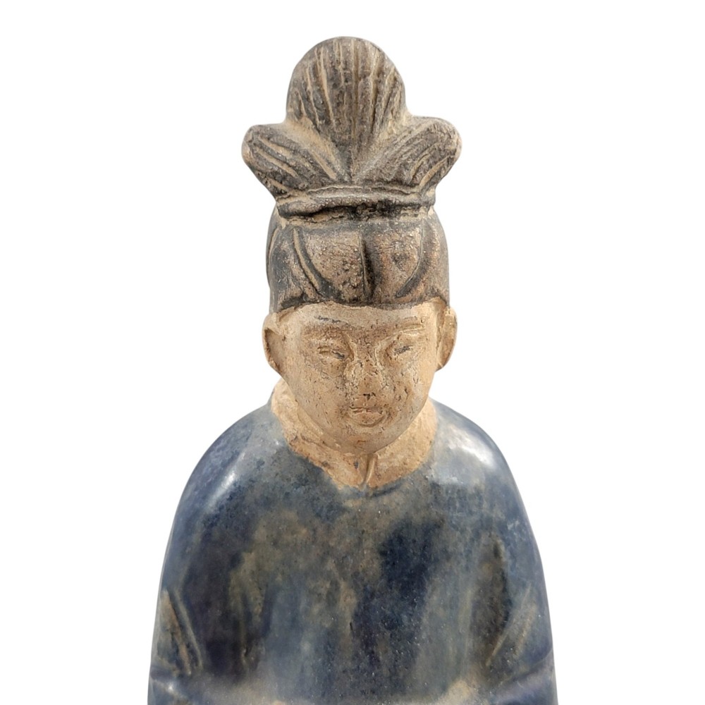 A Chinese Tang dynasty Sancai glazed earthenware figure of a court attendant standing on a hexagonal base with hands clasped under draped sleeves. View VII