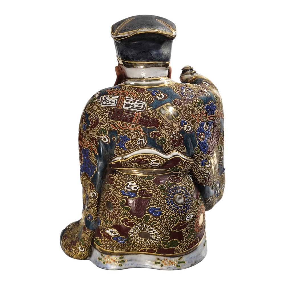 A Japanese Kutani porcelain figurine depicting Jurojin with a long white beard holding a staff, decorated in polychrome overglaze enamels and gold details. View IV