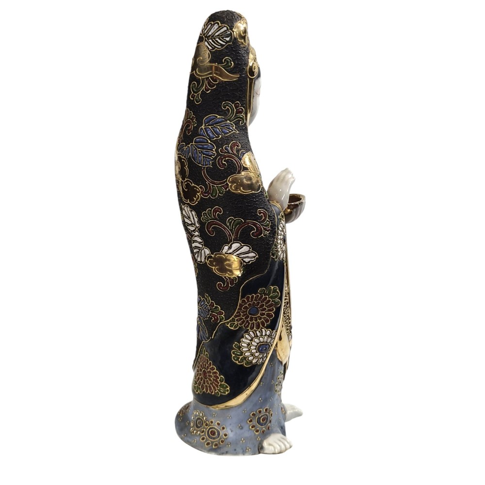 A standing Japanese Kutani porcelain figurine of Kannon with detailed black and gold enamelled robes and a white glazed face. View IV