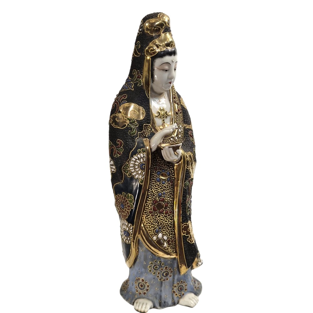 A standing Japanese Kutani porcelain figurine of Kannon with detailed black and gold enamelled robes and a white glazed face. View V
