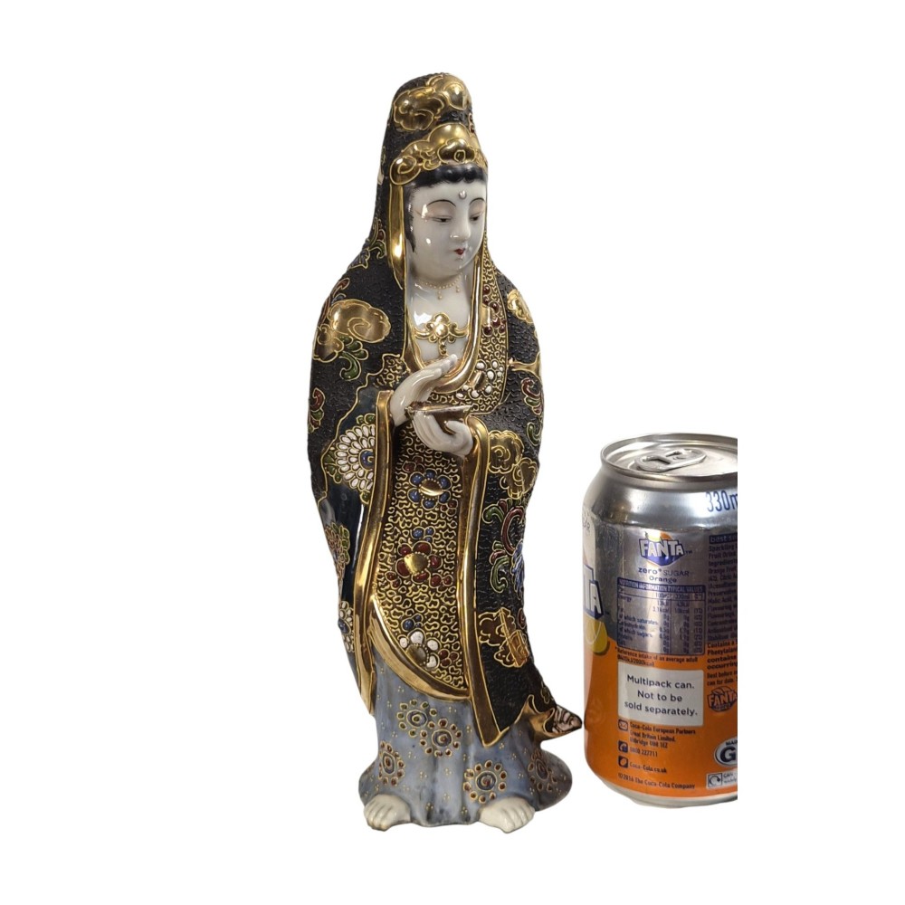 A standing Japanese Kutani porcelain figurine of Kannon with detailed black and gold enamelled robes and a white glazed face. View VI