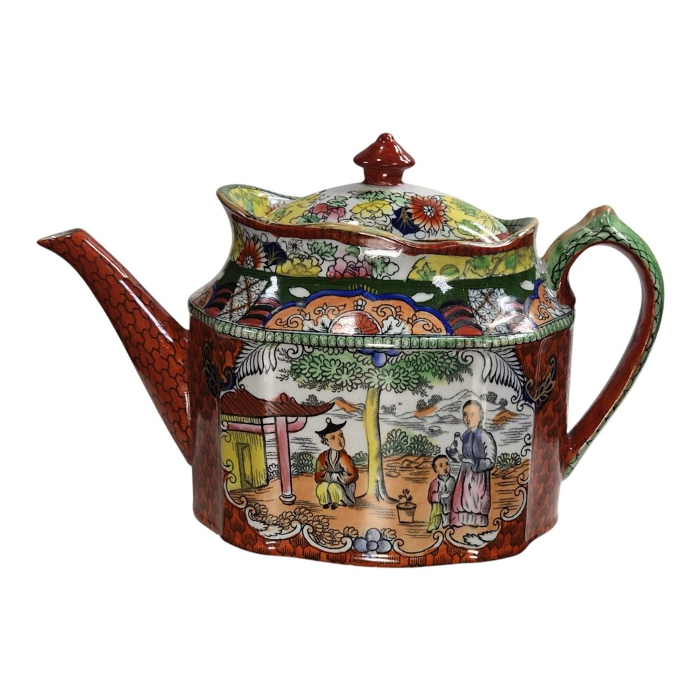 An antique Masons ironstone oval teapot featuring a red scale pattern and a hand-painted Chinoiserie scene with figures. View II