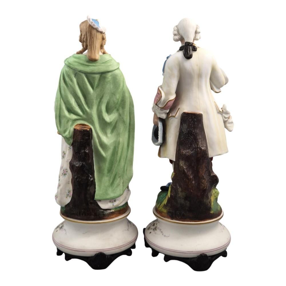 A pair of French biscuit porcelain figures depicting a male and female figure in 18th-century court costume with polychrome enamelled details. View III