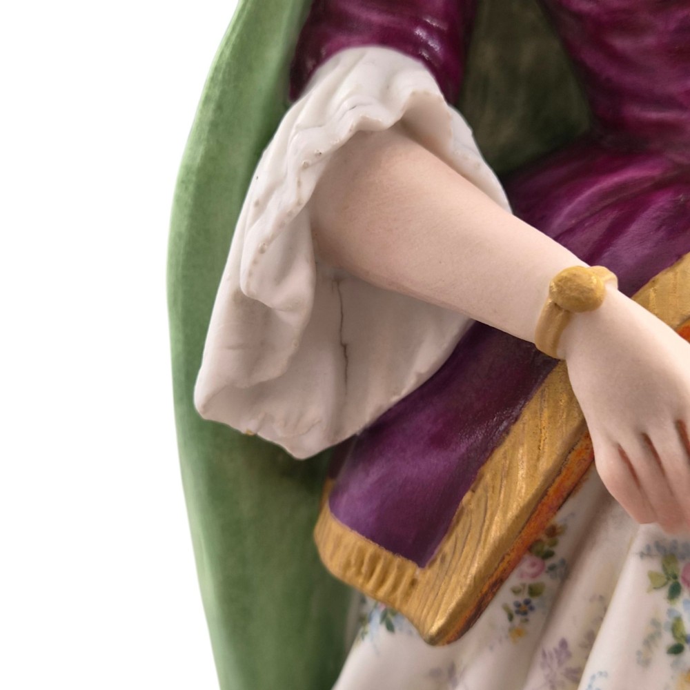 A pair of French biscuit porcelain figures depicting a male and female figure in 18th-century court costume with polychrome enamelled details. View V