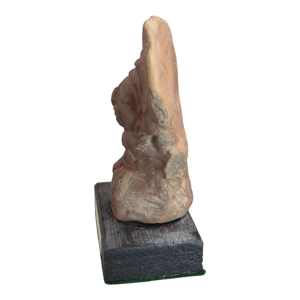 A Pre-Columbian earthenware terracotta sculpture depicting a seated female figure with a flared headdress, mounted on a rectangular dark wooden base. View II