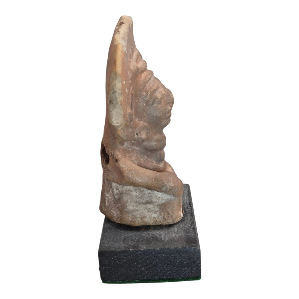 A Pre-Columbian earthenware terracotta sculpture depicting a seated female figure with a flared headdress, mounted on a rectangular dark wooden base. View IV