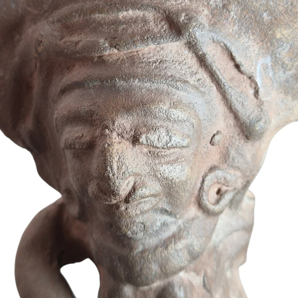 A Pre-Columbian earthenware terracotta sculpture depicting a seated female figure with a flared headdress, mounted on a rectangular dark wooden base. View IX