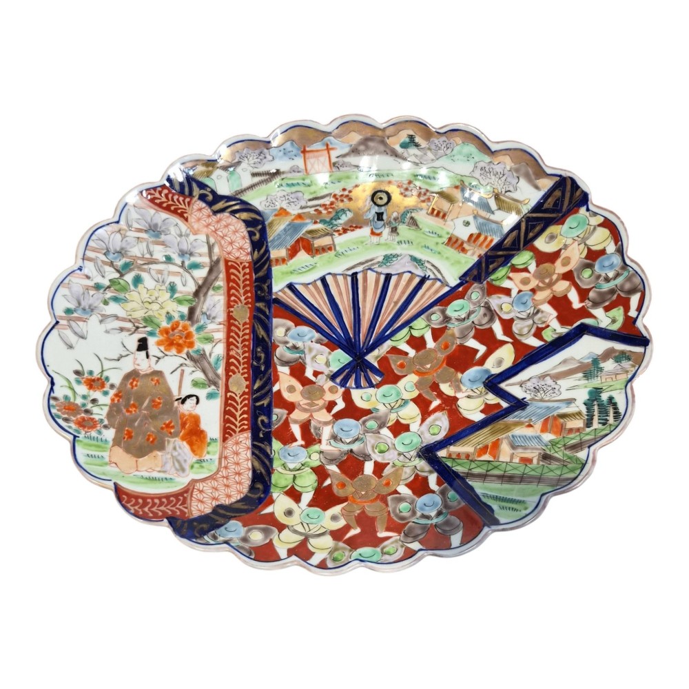 A pair of round antique Japanese Arita Imari porcelain charger plates featuring scalloped edges, fan motifs, landscape scenes, and iron red, cobalt blue, and green enamels. View IV