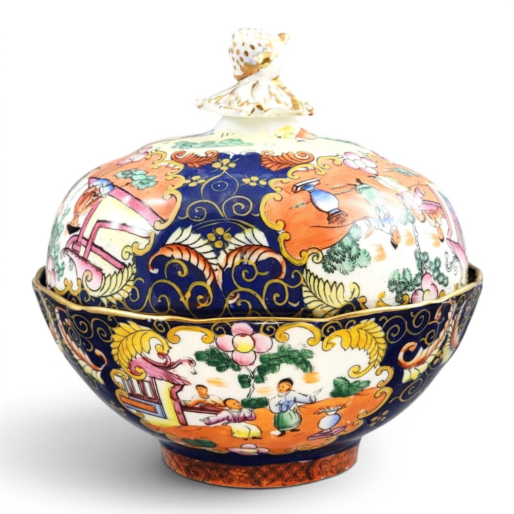 A Regency-era Masons Patent Ironstone lidded bowl decorated with elaborate Chinoiserie motifs in cobalt blue, orange, green, and gilt detailing.