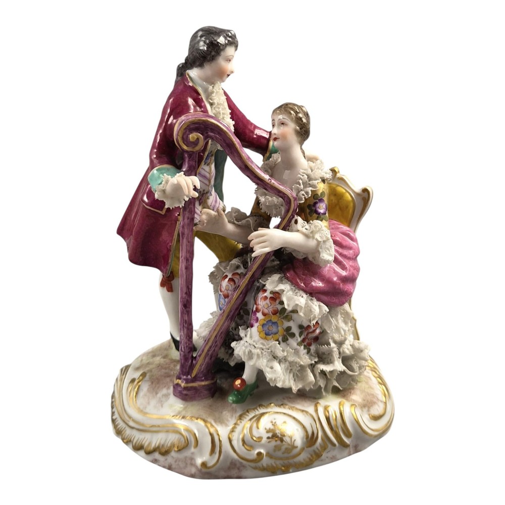 A 19th-century Paris porcelain figural group depicting a man standing behind a seated woman playing a harp, featuring porcelain lace trim and gold scrollwork. View VII