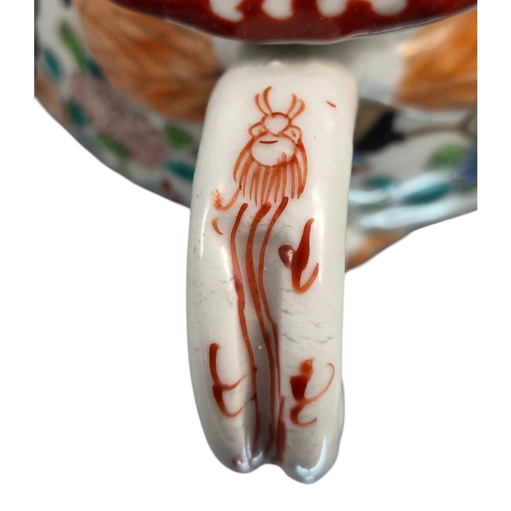 A covered Japanese Imari porcelain sugar bowl featuring double side handles, a pointed gilded finial, and hand-painted samurai and floral motifs in red, blue, green, and gold enamels. View IX
