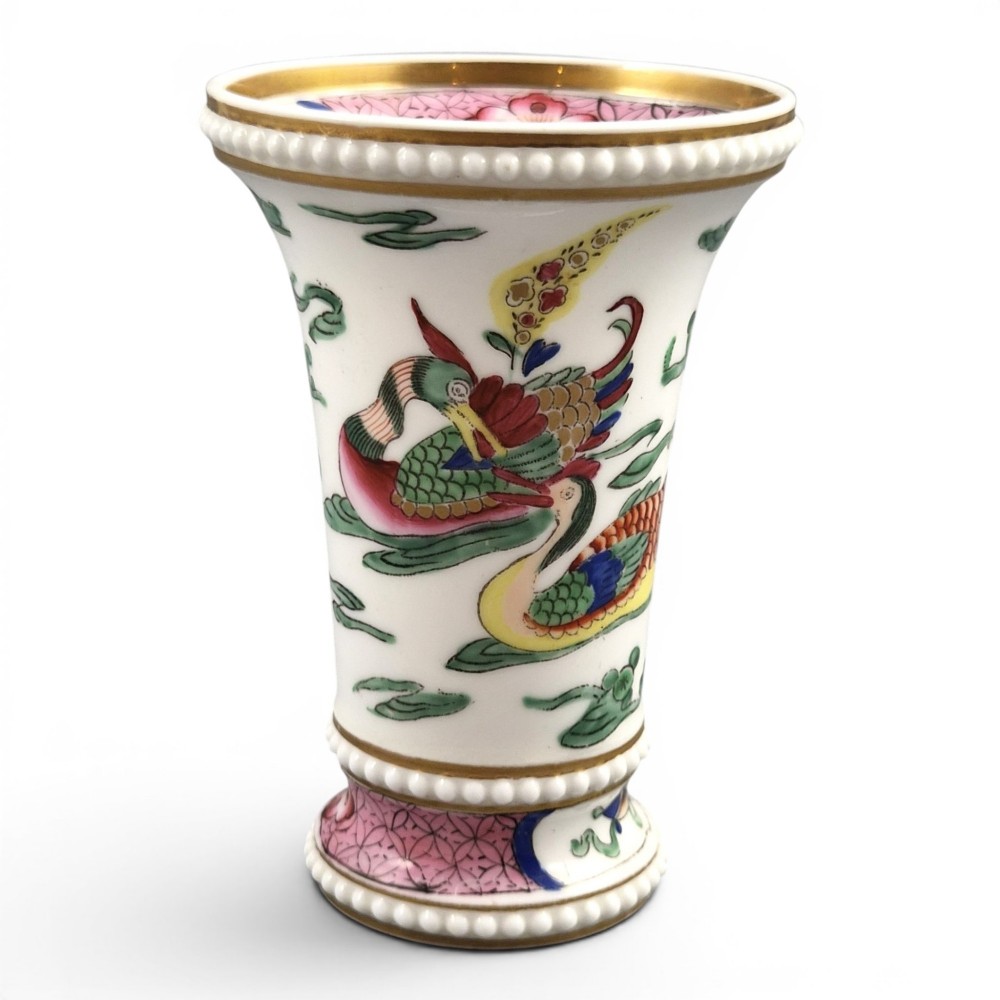 A flared white Regency porcelain spill vase decorated with hand-painted ducks, lotus leaves, beaded borders, and gilded rims.