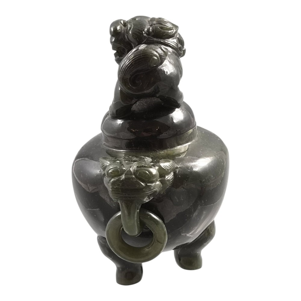 A hand-carved dark green jade tripod censer featuring a foo dog lid finial and lion mask handles with carved loose rings. View IV