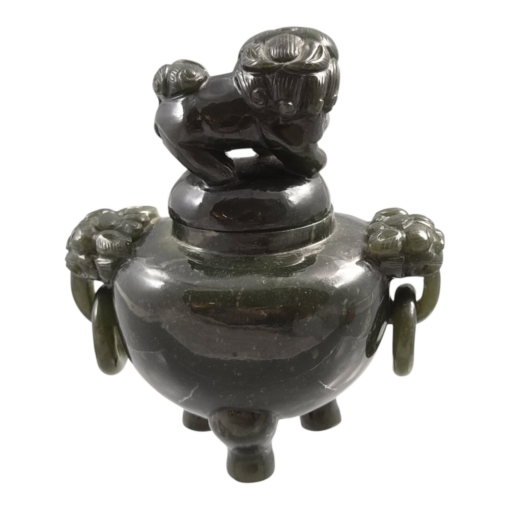 A hand-carved dark green jade tripod censer featuring a foo dog lid finial and lion mask handles with carved loose rings. View VI