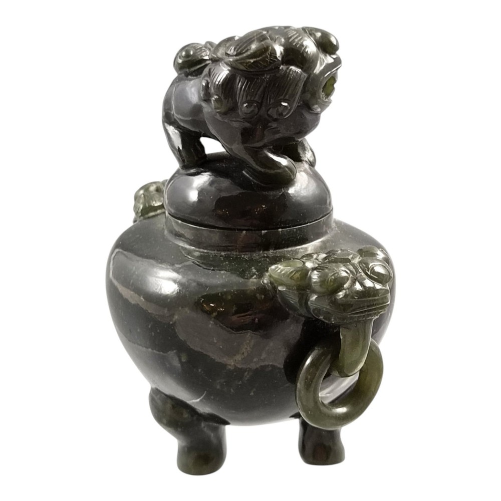 A hand-carved dark green jade tripod censer featuring a foo dog lid finial and lion mask handles with carved loose rings. View VII