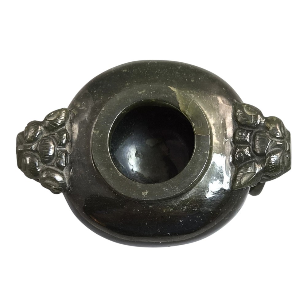 A hand-carved dark green jade tripod censer featuring a foo dog lid finial and lion mask handles with carved loose rings. View IX