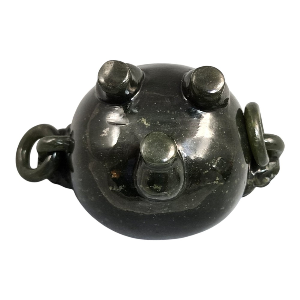 A hand-carved dark green jade tripod censer featuring a foo dog lid finial and lion mask handles with carved loose rings. View X