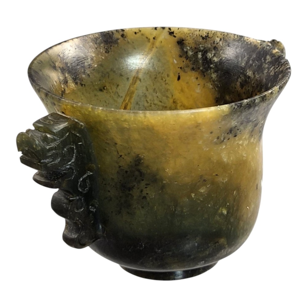 A hand-carved mottled olive-green and dark ochre nephrite jade cup featuring carved handles on either side. View III