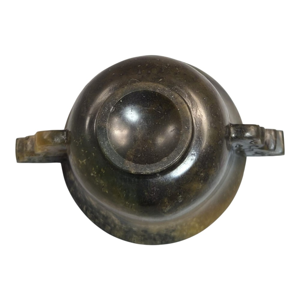 A hand-carved mottled olive-green and dark ochre nephrite jade cup featuring carved handles on either side. View VIII