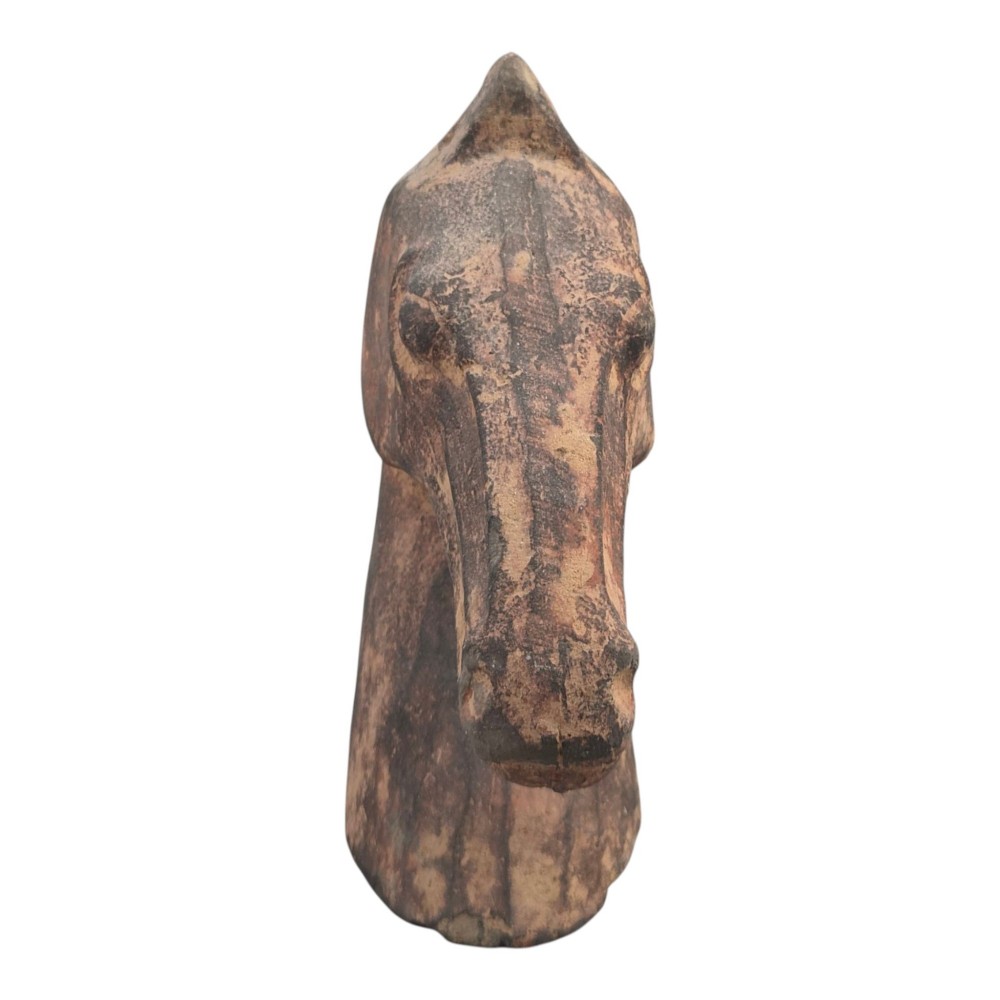 A painted terracotta sculpture depicting the profile of a horse head with earthy red and dark charcoal surface pigments. View III