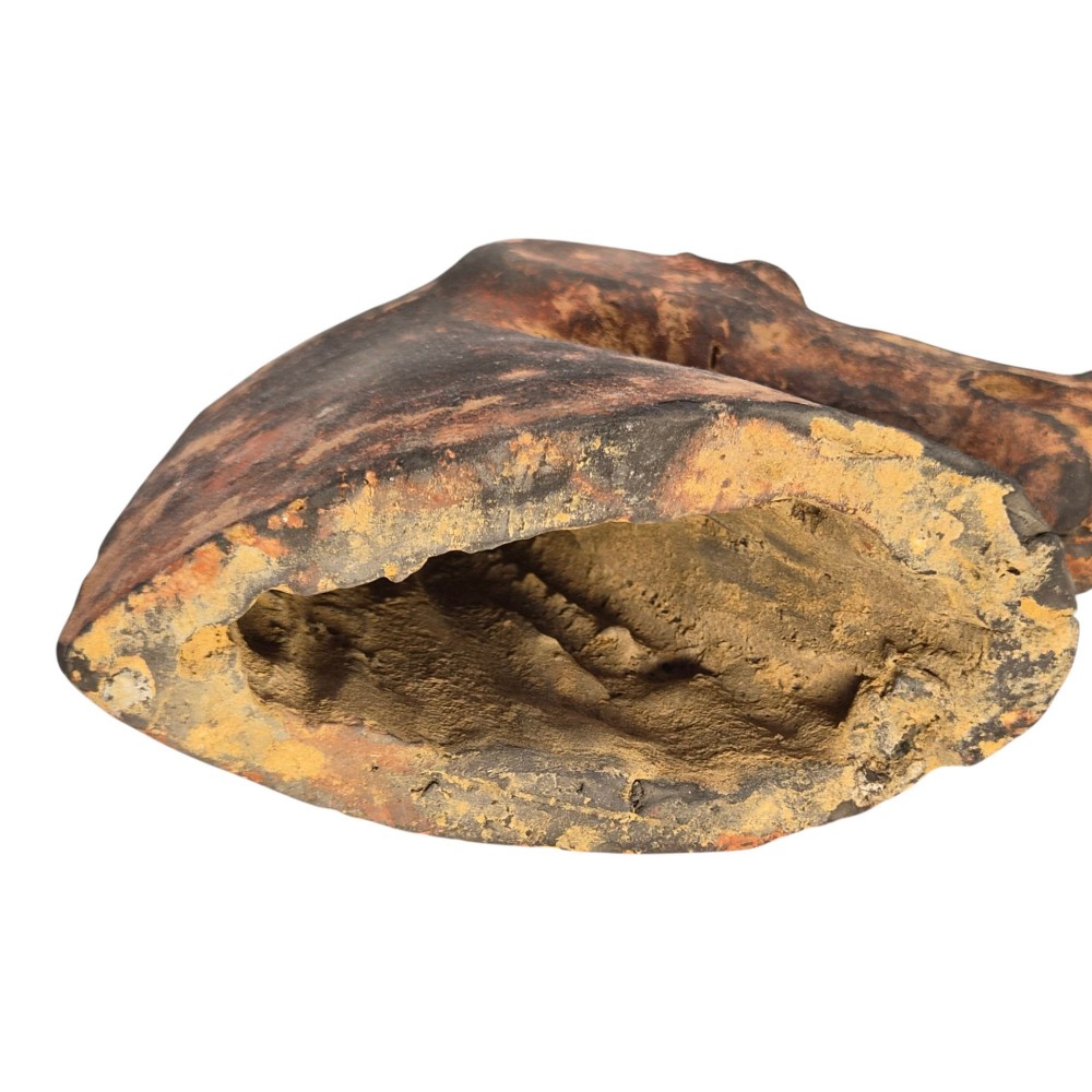 A painted terracotta sculpture depicting the profile of a horse head with earthy red and dark charcoal surface pigments. View VIII