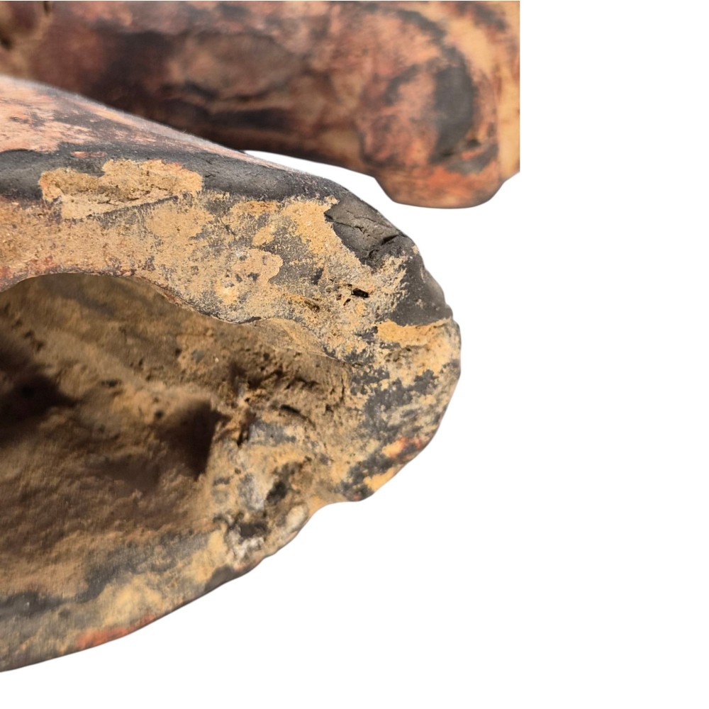 A painted terracotta sculpture depicting the profile of a horse head with earthy red and dark charcoal surface pigments. View IX