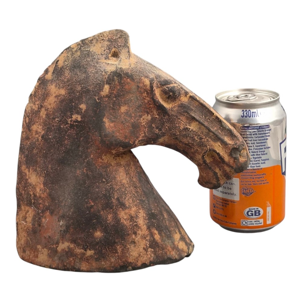 A painted terracotta sculpture depicting the profile of a horse head with earthy red and dark charcoal surface pigments. View XIII