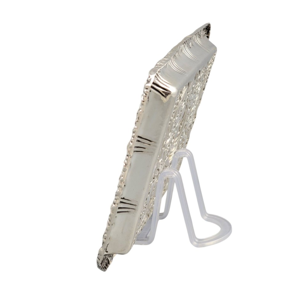 A rectangular Edwardian sterling silver card tray with intricate floral repousse scrollwork detailing, a plain central cartouche, and a raised scalloped rim. View VII