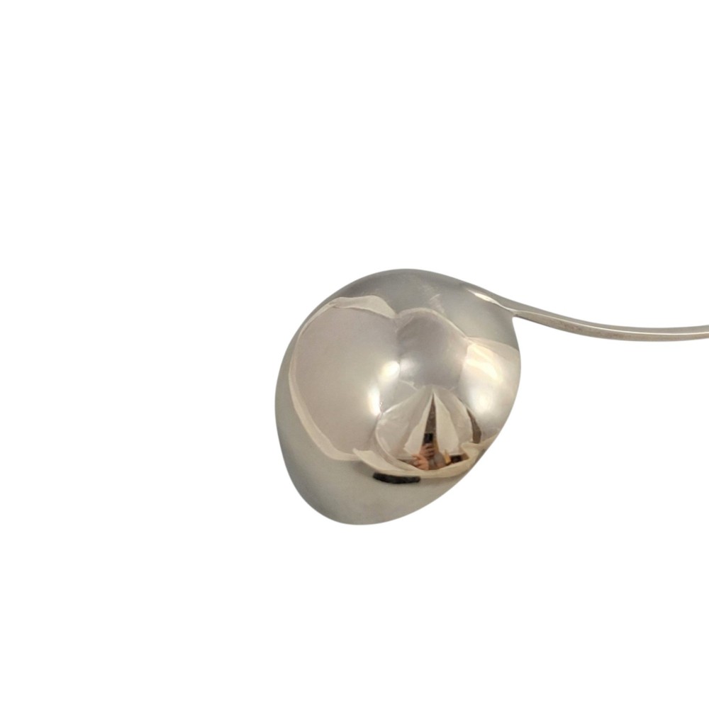 A Georgian sterling silver soup ladle featuring a deep circular bowl, a long curved stem in the Old English pattern, and an engraved crest near the handle tip. View IV