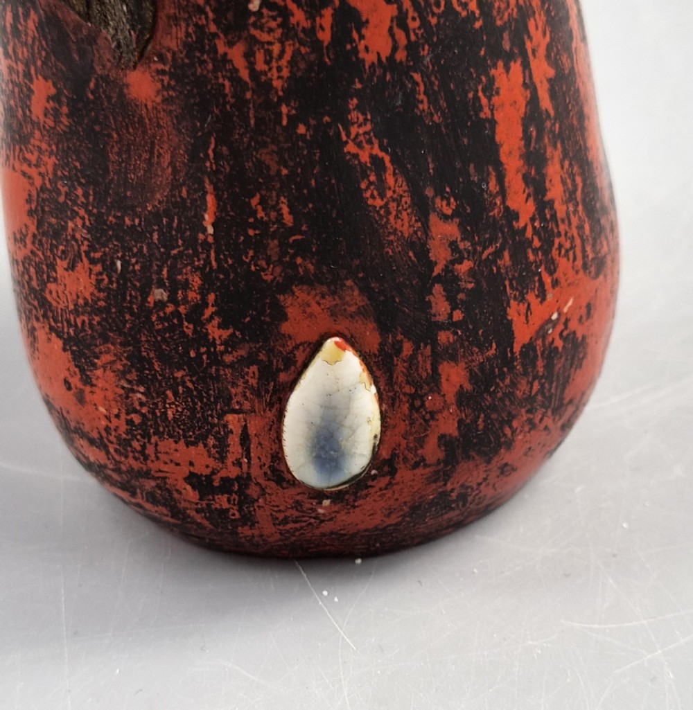 A Japanese Sumida Gawa pottery vase featuring an asymmetrical spouted form with a dark flambe drip glaze over a textured red lower body adorned with applied high-relief figures of boys. View IX