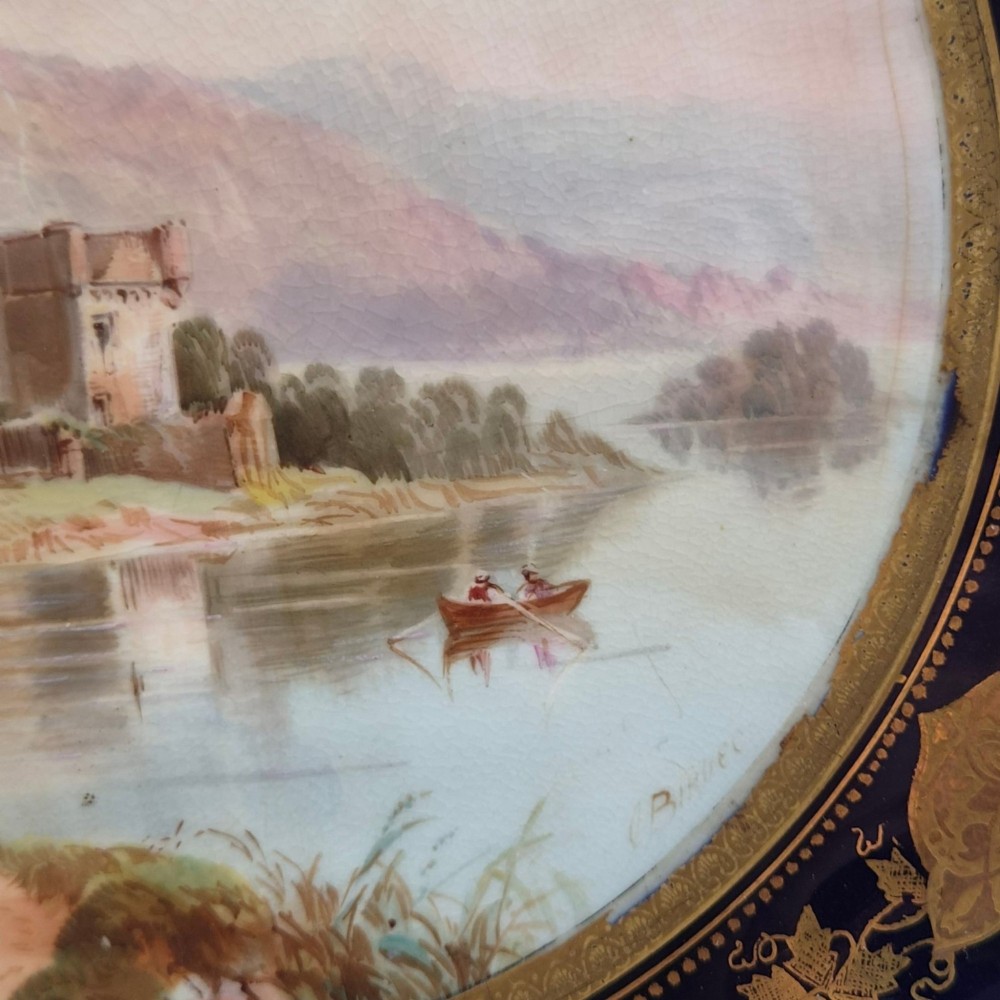 A set of four late nineteenth-century Aynsley porcelain cabinet plates featuring hand-painted landscape scenes surrounded by cobalt blue rims with heavy gold foliage gilding. View XI