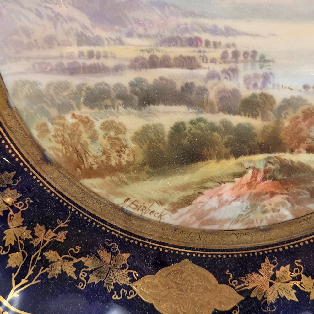 A set of four late nineteenth-century Aynsley porcelain cabinet plates featuring hand-painted landscape scenes surrounded by cobalt blue rims with heavy gold foliage gilding. View XIII