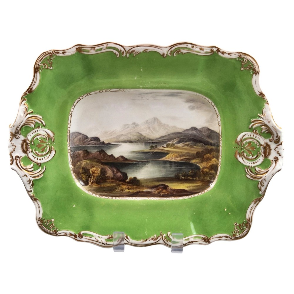 A pair of rectangular porcelain serving dishes featuring apple green borders with gilded scrollwork and central hand-painted landscape scenes. View II