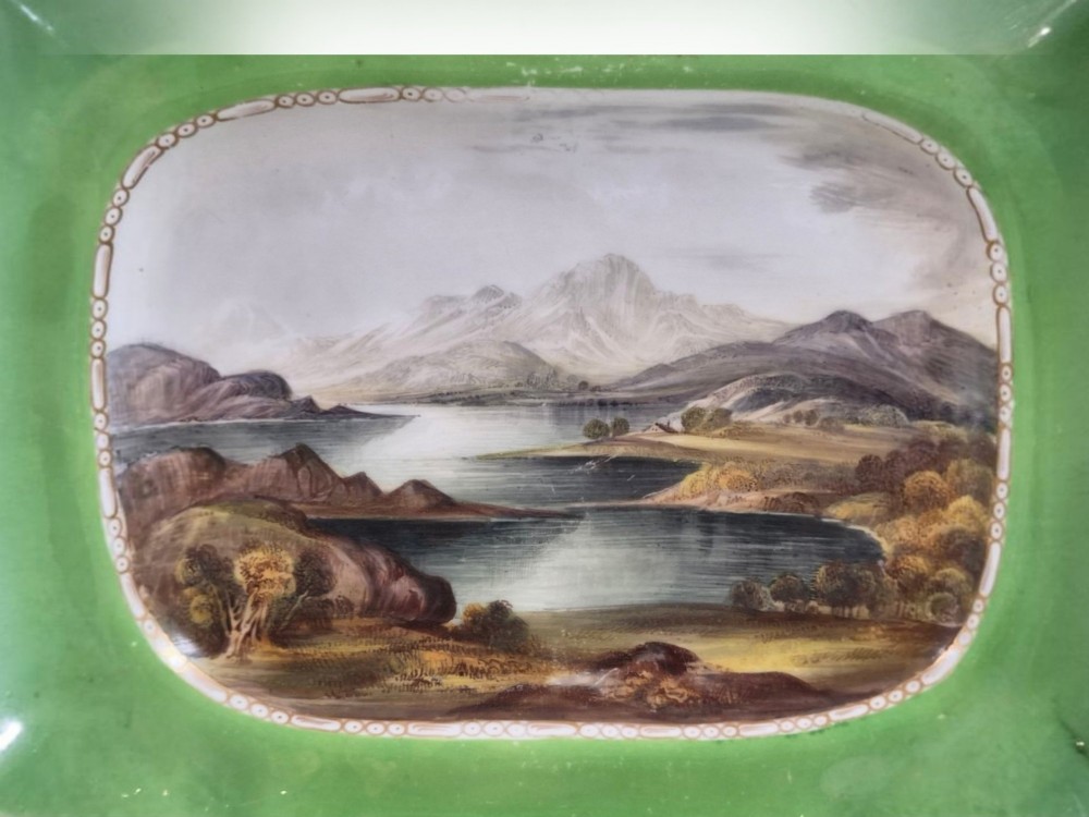 A pair of rectangular porcelain serving dishes featuring apple green borders with gilded scrollwork and central hand-painted landscape scenes. View III