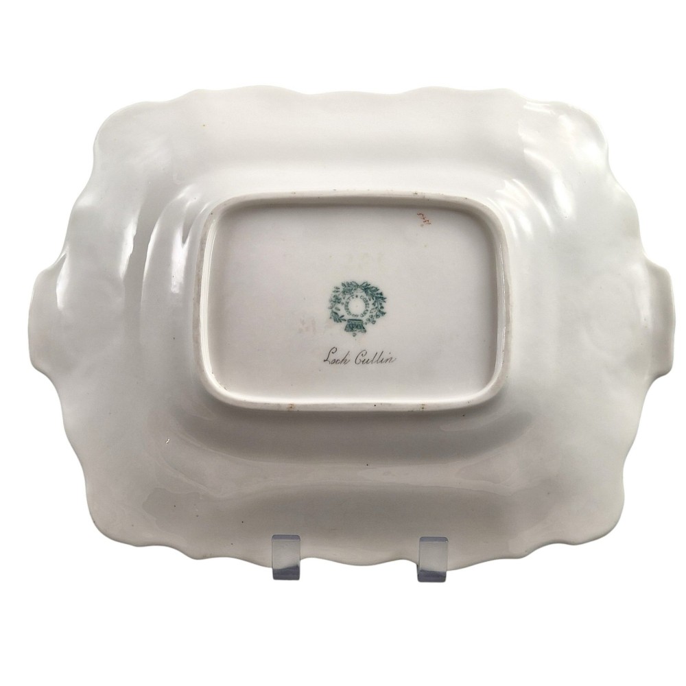 A pair of rectangular porcelain serving dishes featuring apple green borders with gilded scrollwork and central hand-painted landscape scenes. View IV