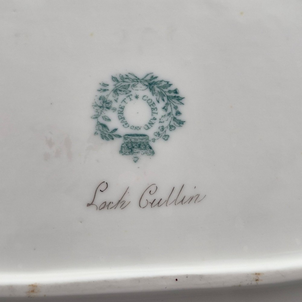 A pair of rectangular porcelain serving dishes featuring apple green borders with gilded scrollwork and central hand-painted landscape scenes. View V