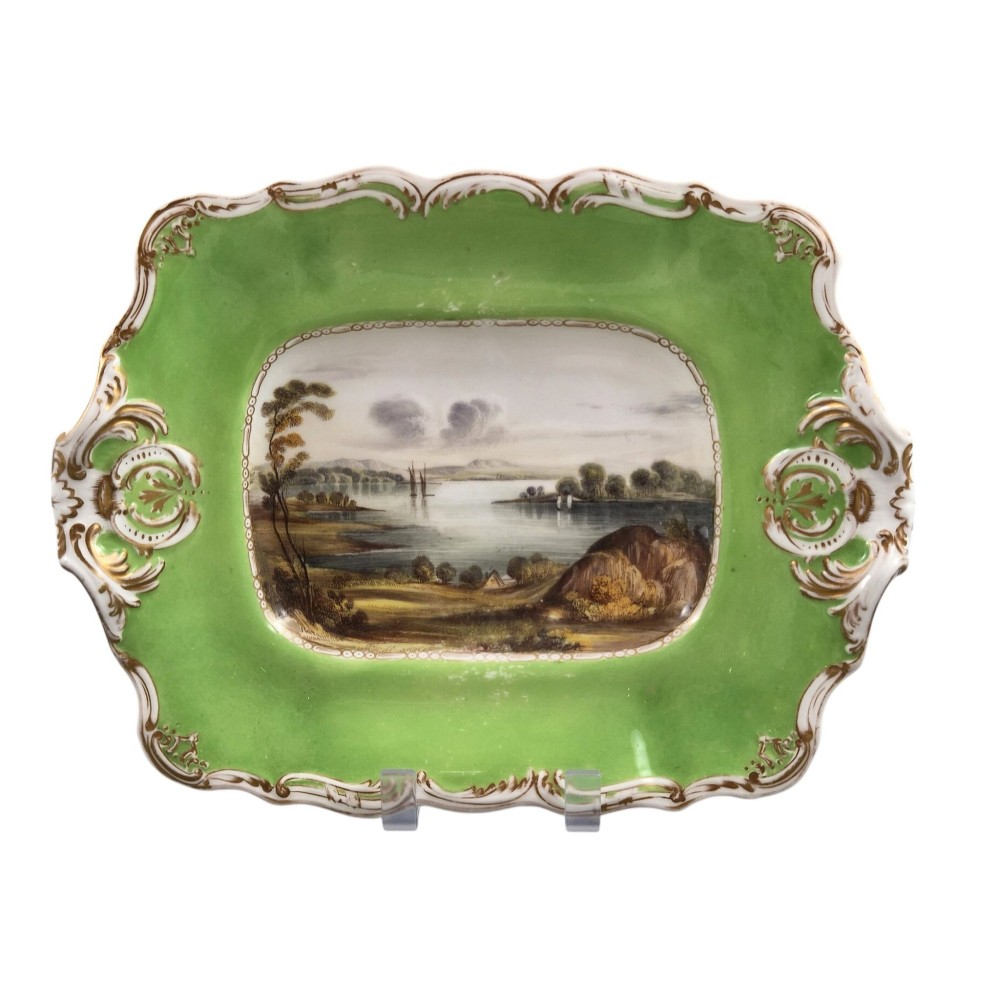 A pair of rectangular porcelain serving dishes featuring apple green borders with gilded scrollwork and central hand-painted landscape scenes. View VIII