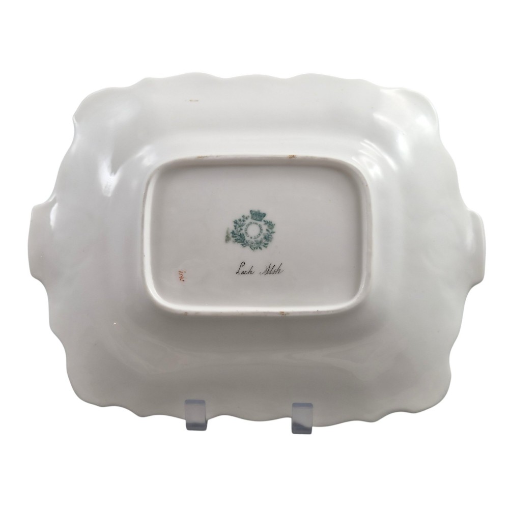 A pair of rectangular porcelain serving dishes featuring apple green borders with gilded scrollwork and central hand-painted landscape scenes. View XI