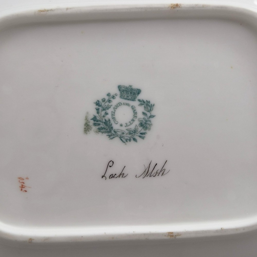 A pair of rectangular porcelain serving dishes featuring apple green borders with gilded scrollwork and central hand-painted landscape scenes. View XII