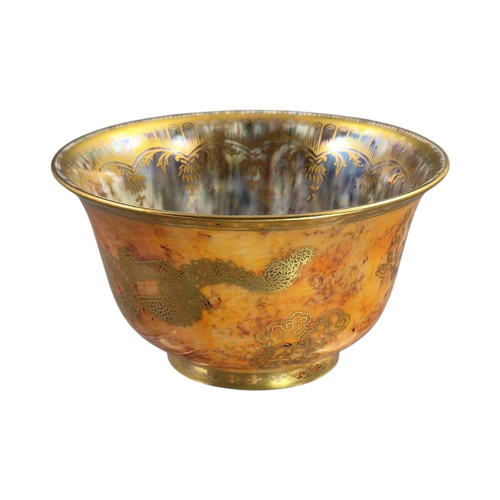 An antique ceramic bowl with a mottled orange lustre glaze on the exterior, decorated with a gold gilded dragon, and a pearlescent interior with a gilded scalloped border. View V