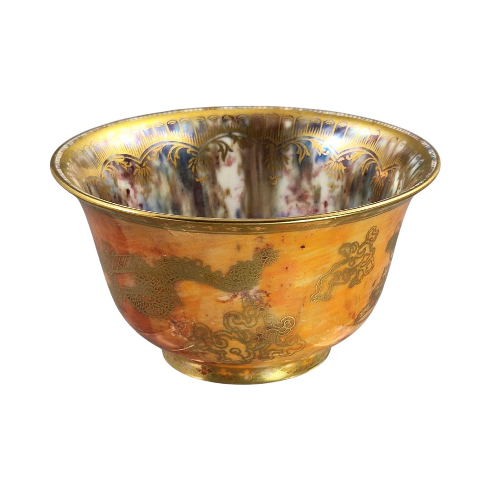 An antique ceramic bowl with a mottled orange lustre glaze on the exterior, decorated with a gold gilded dragon, and a pearlescent interior with a gilded scalloped border. View IX